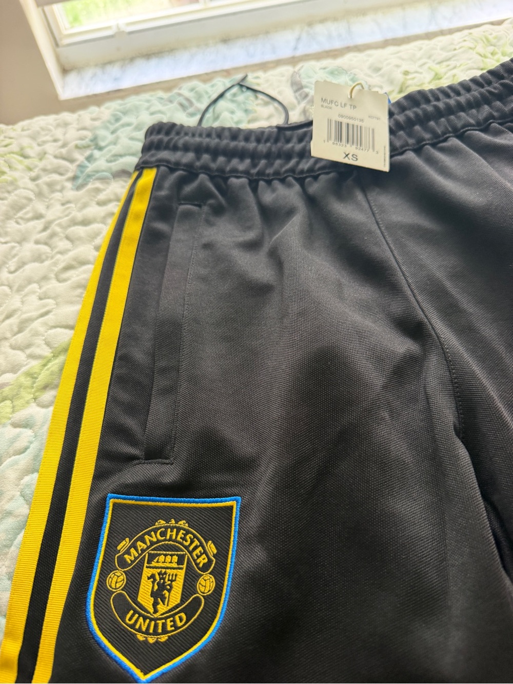adidas Black Sweatpants with Yellow Side Stripes and Manchester United Crest